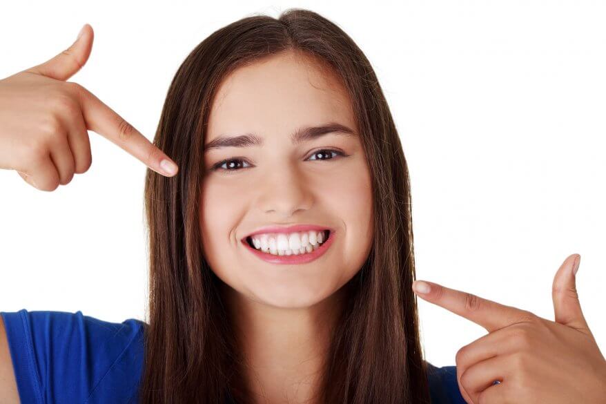 long haired woman showing her North Miami Dentist her perfect smile after teeth cleaning